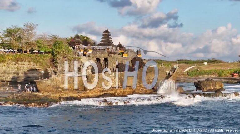 Aerial view of Pura Tanah Lot temple and beach at sunset, shot by Drone, Bali, Indonesia on HOsiHO.com